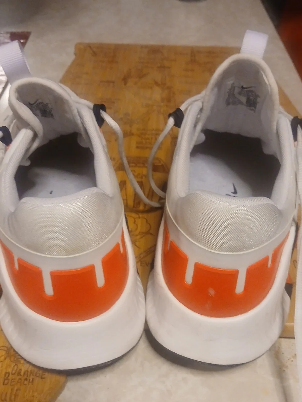 Nike Men’s White Athletic Shoes with Orange and Black Accents